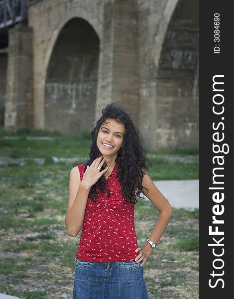 Beautiful smiling young woman in red on street. Beautiful smiling young woman in red on street