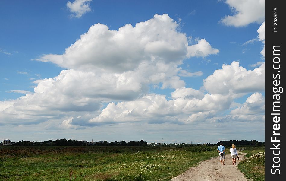 The summer sky and country road and persons outgoing. The summer sky and country road and persons outgoing