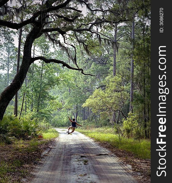 Woman going fishing jumps for joy on country road in Deep South of the U.S. Woman going fishing jumps for joy on country road in Deep South of the U.S.