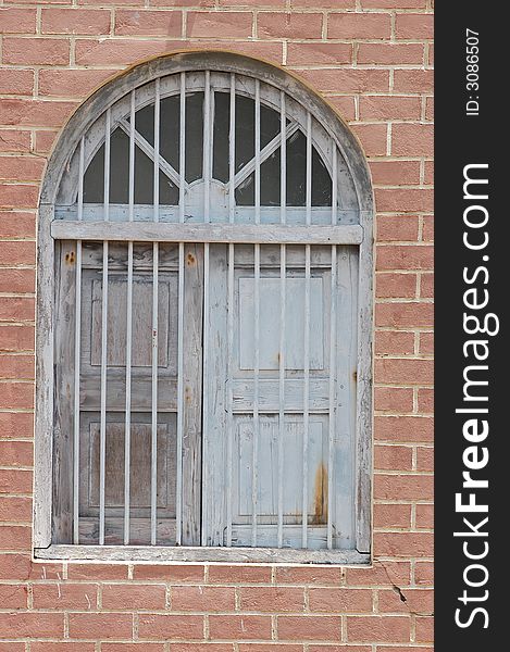 Home Window with Red Bricks and Grill