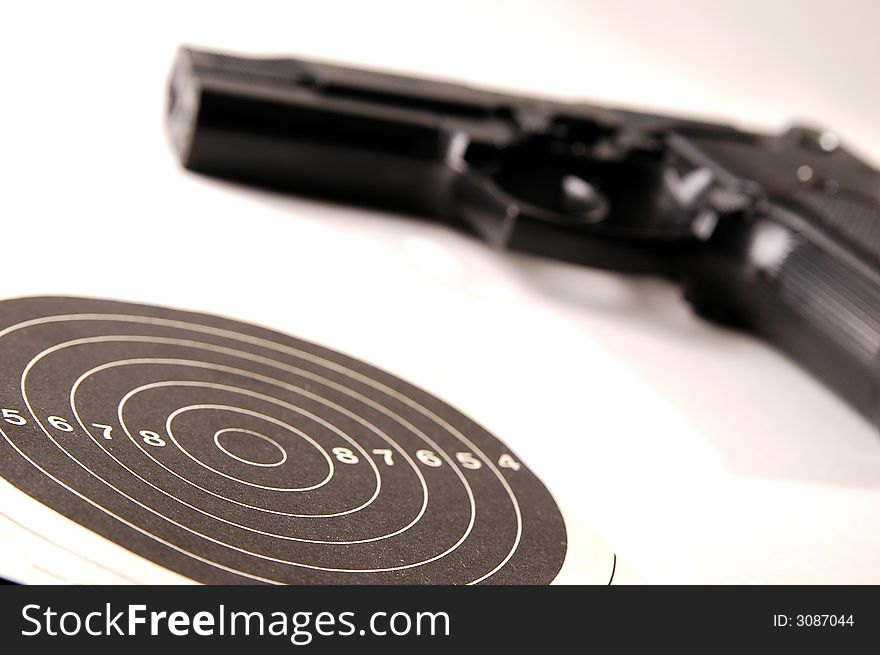 Photo of black gun on the white background