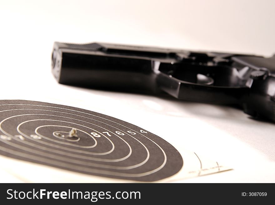 Photo of black gun on the white background