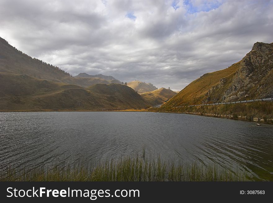 Mountain lake in the Swiss Alpes in cloudy autumn day. Mountain lake in the Swiss Alpes in cloudy autumn day