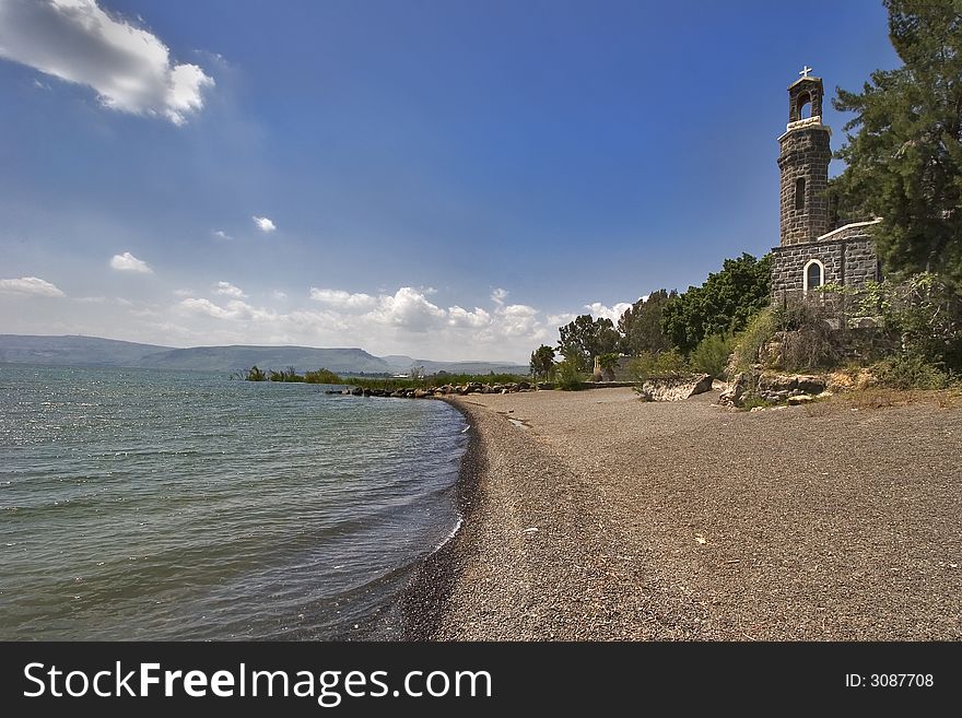 Ancient church and trees at coast of lake of Tiberias in the spring. Ancient church and trees at coast of lake of Tiberias in the spring