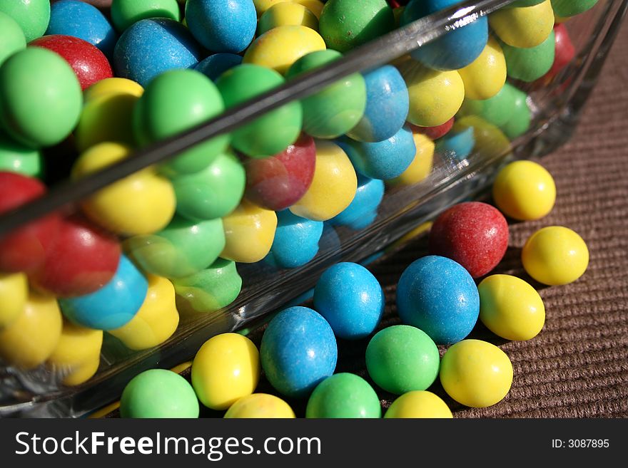 Different coloured sweets in a glass bowl. Different coloured sweets in a glass bowl