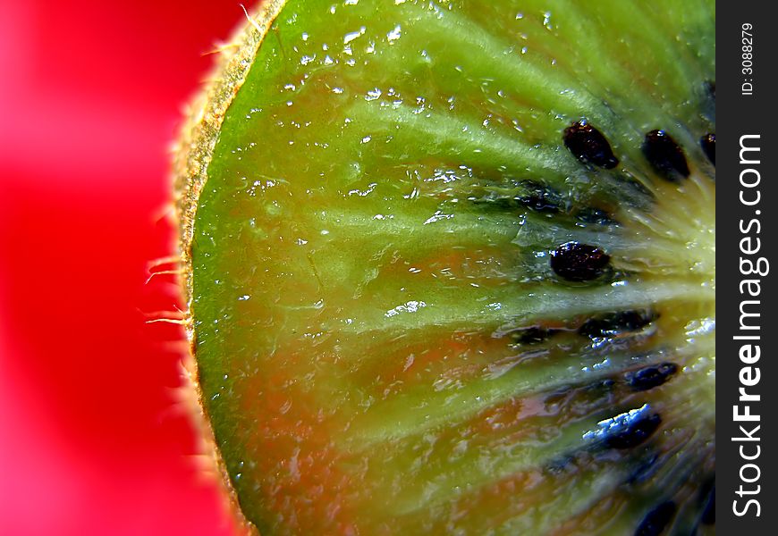 Slice kiwi on red background