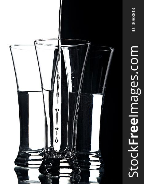 Still life with glasses on the white and black background;