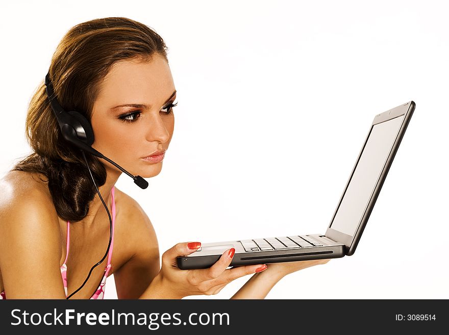 Beautiful brunette girl with a laptop sitting on white background. Beautiful brunette girl with a laptop sitting on white background