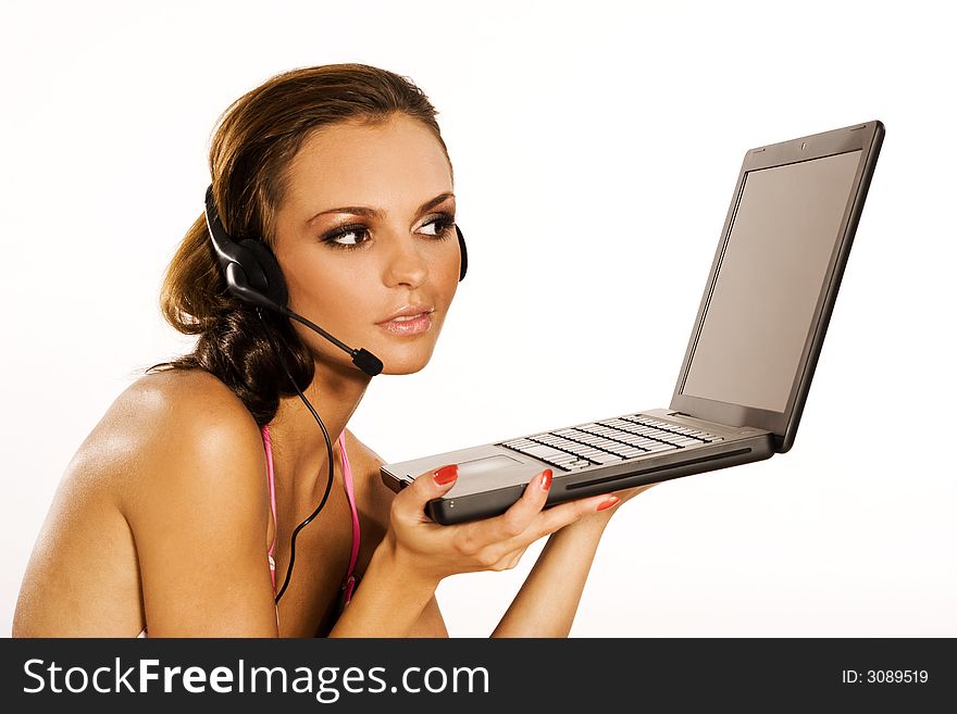 Beautiful brunette girl with a laptop sitting on white background. Beautiful brunette girl with a laptop sitting on white background