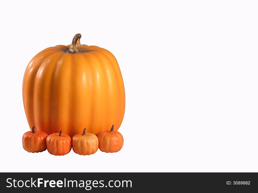 Large pumpkin with three small pumpkins in front of it. Large pumpkin with three small pumpkins in front of it