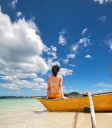 Young Girl Sit On Boat On White Beach Royalty Free Stock Images