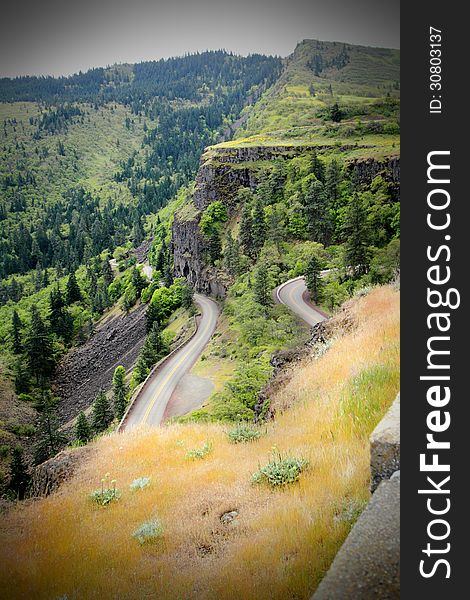 Territorial view of a curvy mountain road under dark skies in Oregon.