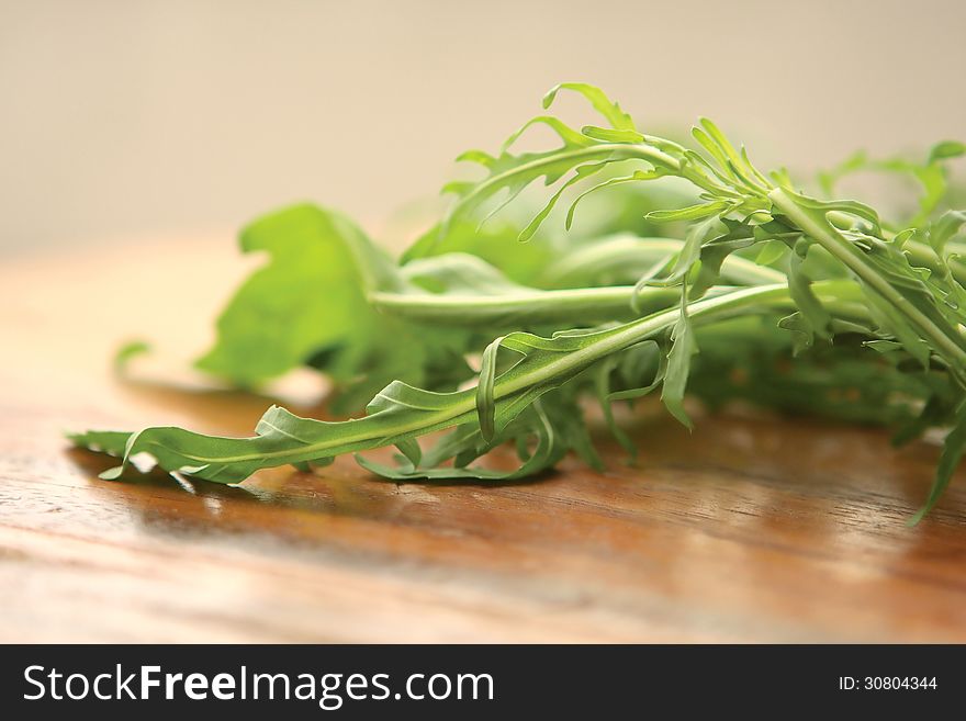 Fresh Green Rucola on a wooden board