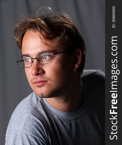 Portrait of young man with glasses in studio