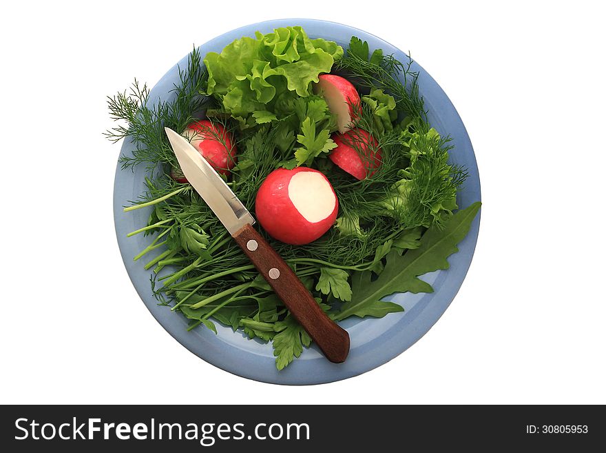 Greens and radishes on a blue plate with a knife