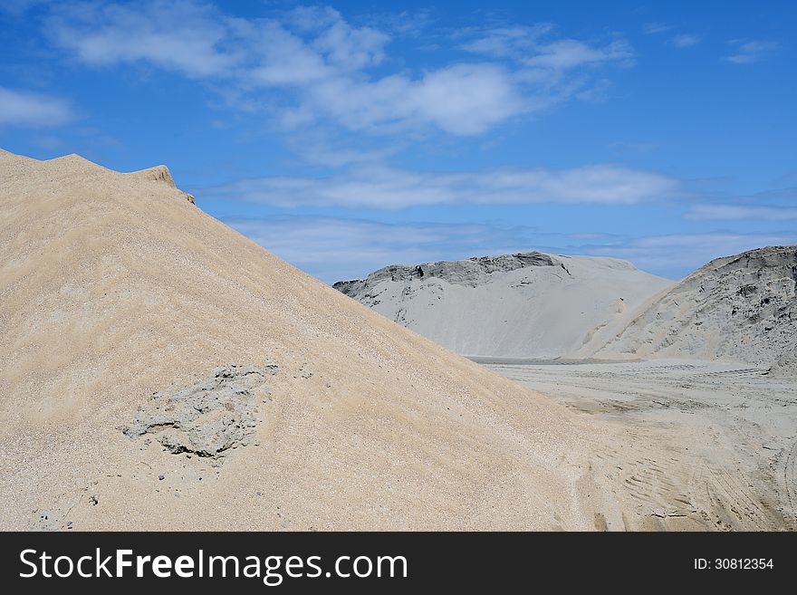 Sand mound against blue sky