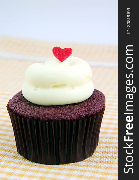 Fanciful cupcake with cream cheese and heart. Fanciful cupcake with cream cheese and heart