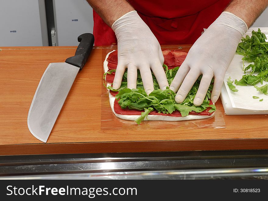 Hand preparing a sandwich