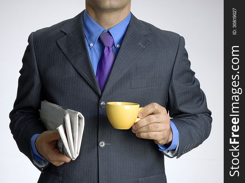 Businessman holding a cup of coffee and news paper. Businessman holding a cup of coffee and news paper.