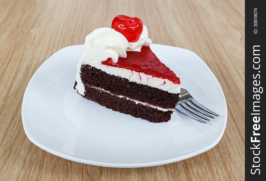 Chocolate cake and fresh cherry