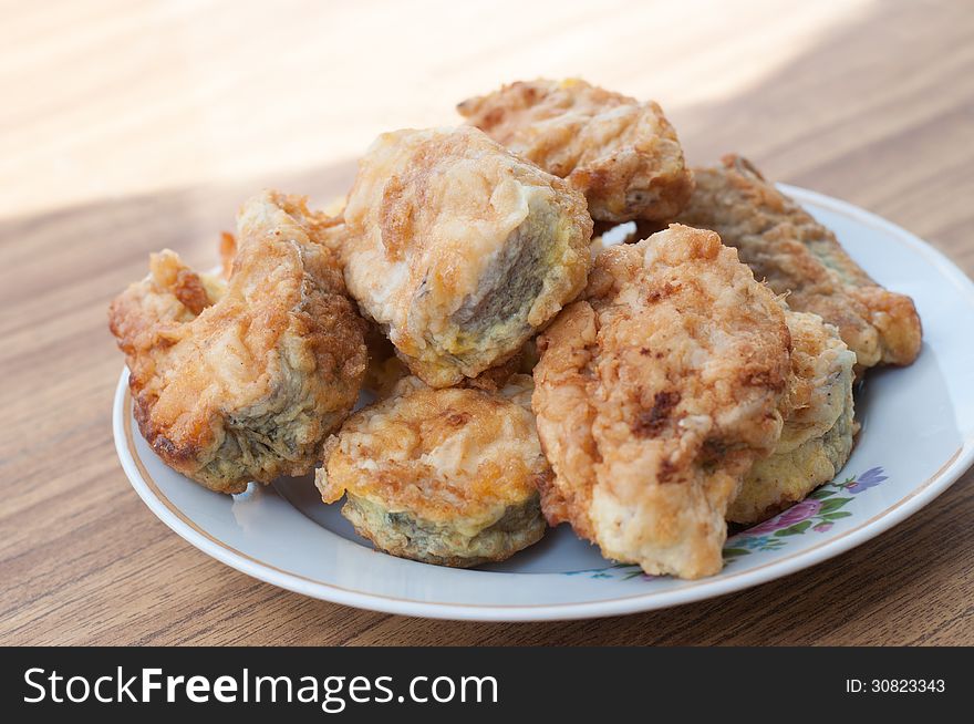 Fish fried on plate on a table