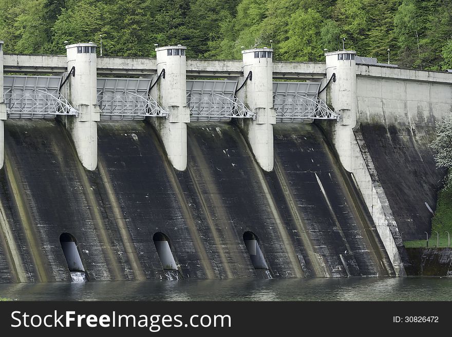 Energy producing power station on a dam at a lake. Energy producing power station on a dam at a lake