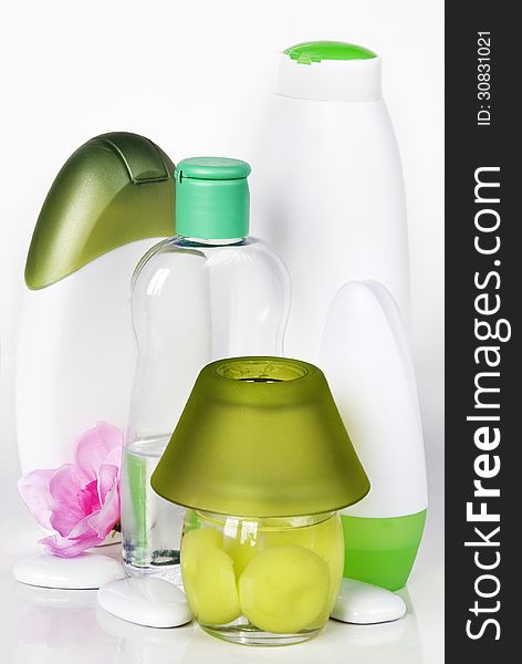 Green and white bottles with different cosmetics. Green and white bottles with different cosmetics