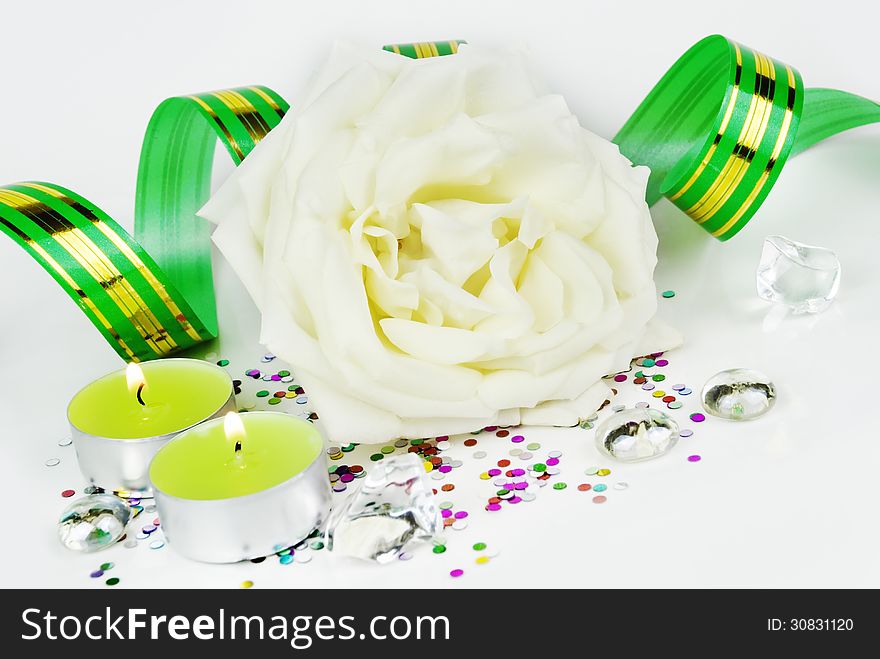 White rose and green burning candles. White rose and green burning candles