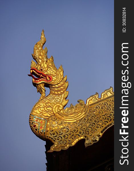 Thai golden dragon on a background of blue sky