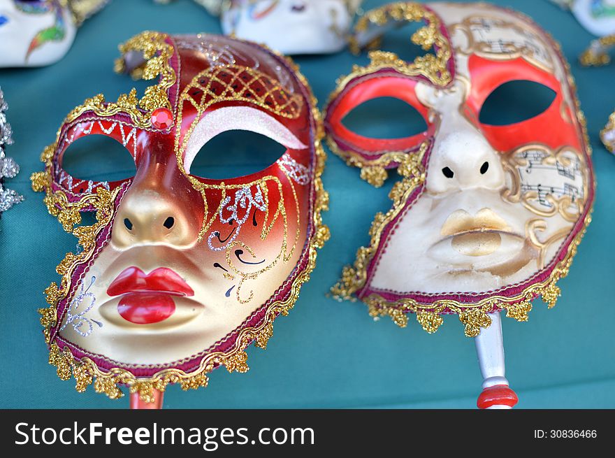two carnival masks with the blue background