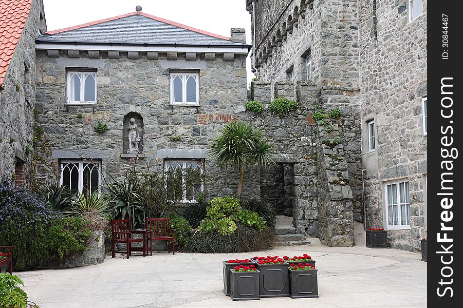 Stone House with planters and chairs in the courtyard. Stone House with planters and chairs in the courtyard