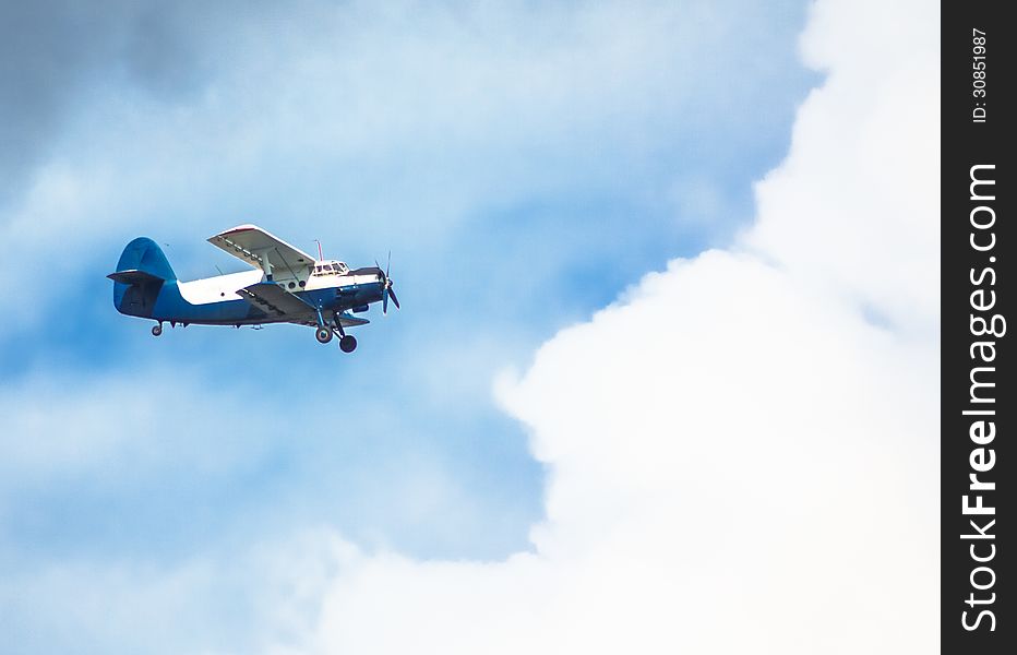 Biplane In Blue Sky Over Clouds. Biplane In Blue Sky Over Clouds