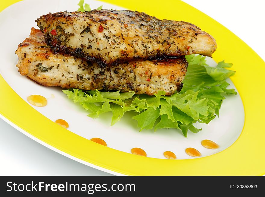 Slices of Roasted Chicken Fillet with Herbs, Lettuce and Honey Sauce on Yellow Plate closeup