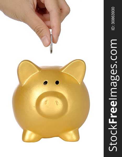 Human hand put coin into piggy bank isolated over white background