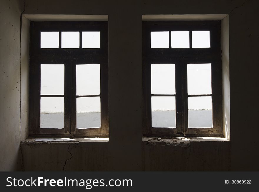 Two old windows in an abandoned building