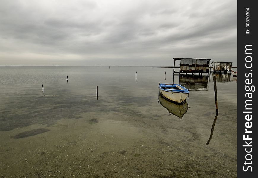 Moored boat with reflection in still waters, Greece Axios outfall. Moored boat with reflection in still waters, Greece Axios outfall