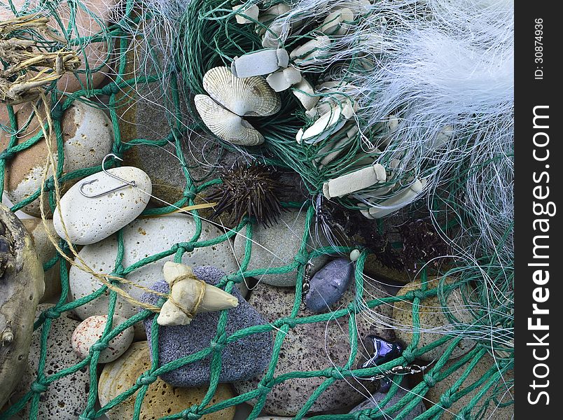 Still life with fishing hooks and net on stones. Still life with fishing hooks and net on stones