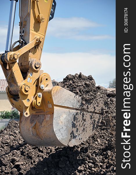 This is a hydraulic excavator with a 2 cubic yard bucket attached, digging in loose soil and rock. This is a hydraulic excavator with a 2 cubic yard bucket attached, digging in loose soil and rock.