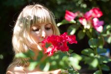 Young Woman With Red Flowers On A Walk Stock Photo Young Woman With Red Flowers On A Walk Stock Photo