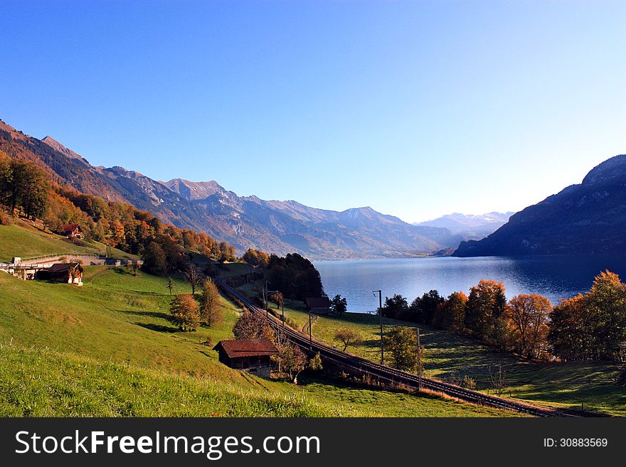 Railway line through the Alps and along a lake in Switzerland.