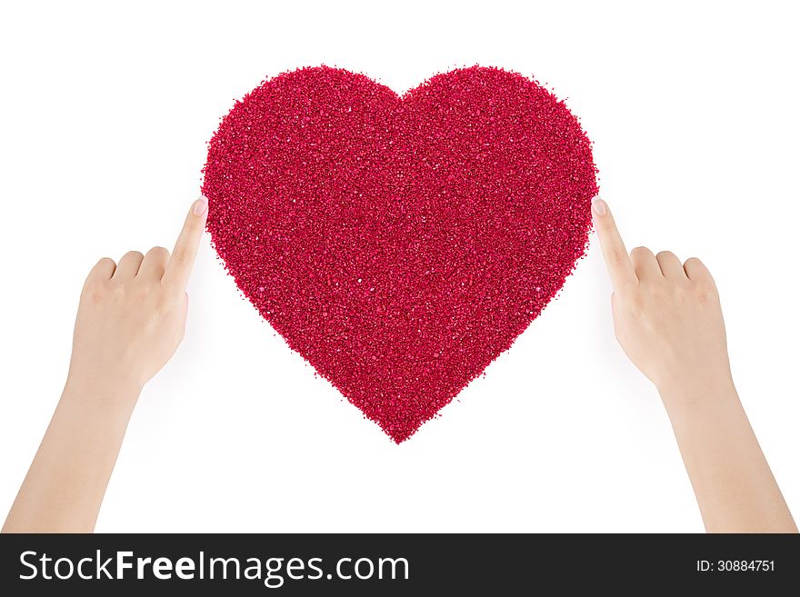 Woman's hands making the heart of red sand by index fingers on white background. Woman's hands making the heart of red sand by index fingers on white background.