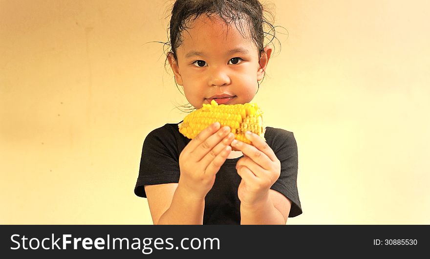 Little girl hold a corn. Little girl hold a corn.