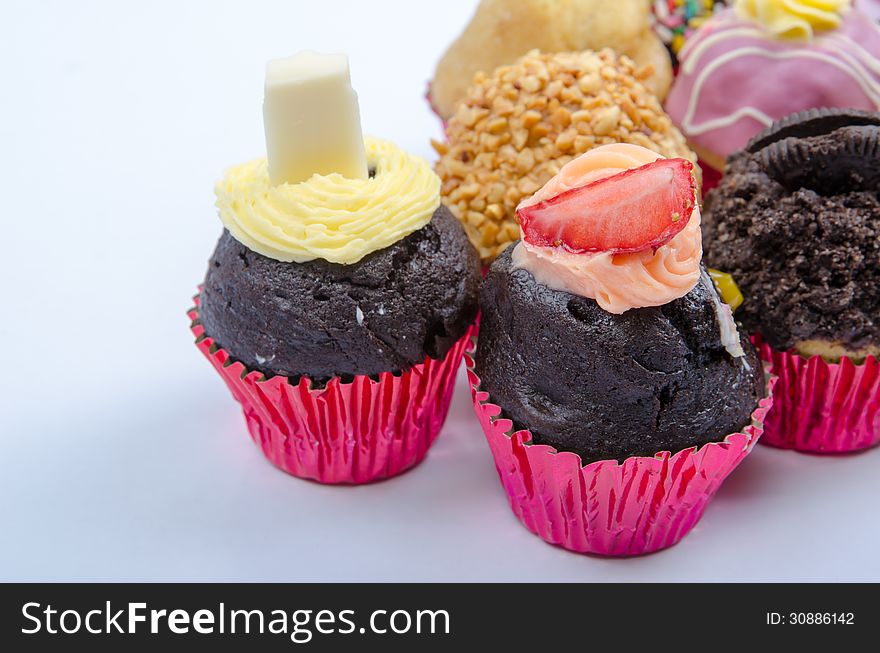 Assorted colorful decorated cupcakes with icing on top