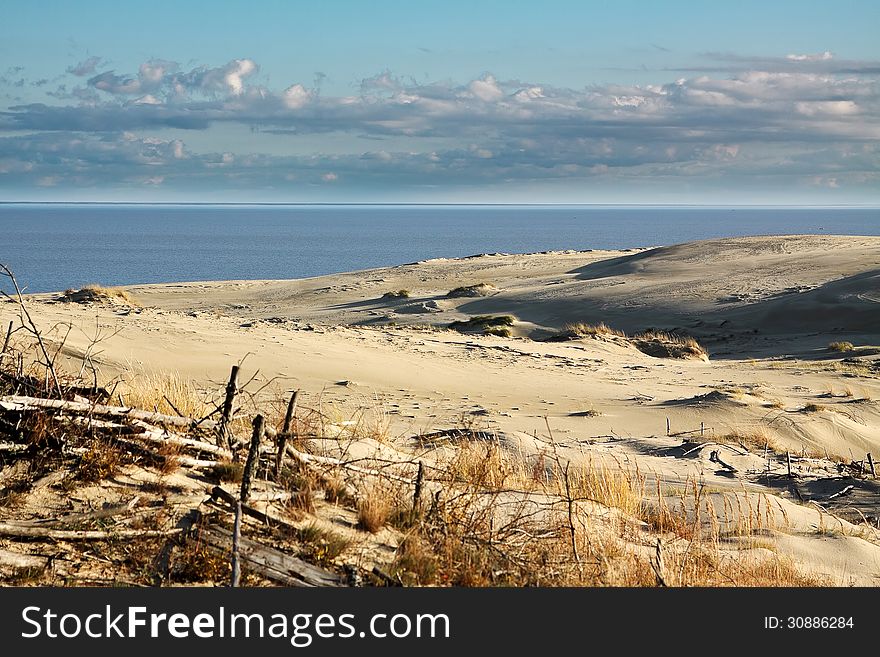 Sand Dune At The Beach With Cloudy Sky