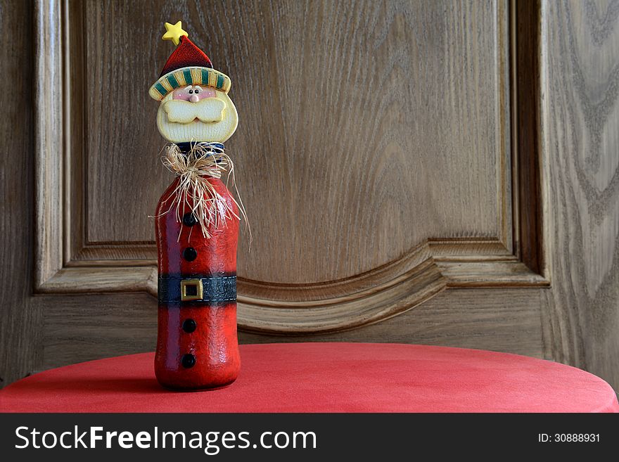 Christmas Ornament made from a bottle standing by the door. Christmas Ornament made from a bottle standing by the door