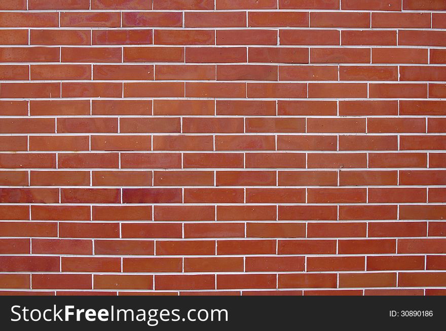 The photograph shows a wall made â€‹â€‹of red bricks. Bricks are combined with white grout. The photograph shows a wall made â€‹â€‹of red bricks. Bricks are combined with white grout.