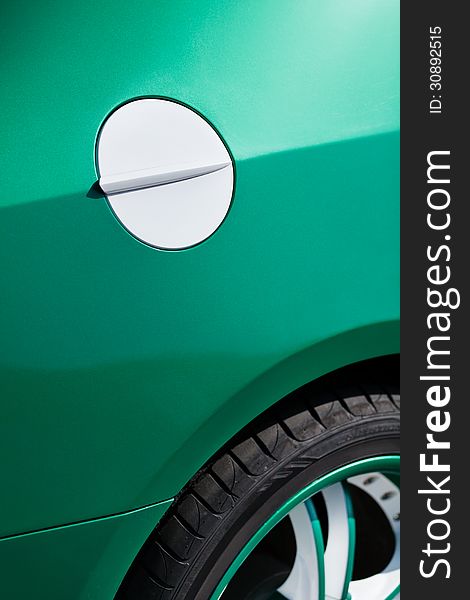 Car fuel tank lid white green closeup