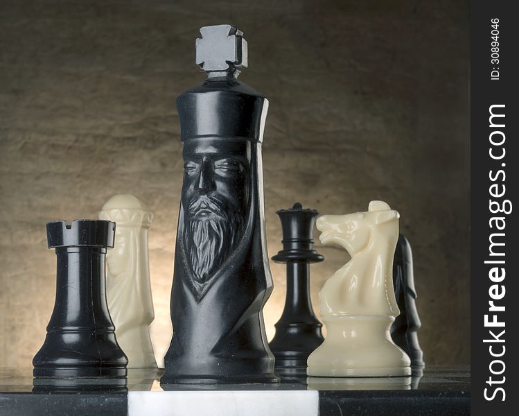 Chess pieces on marble playing board