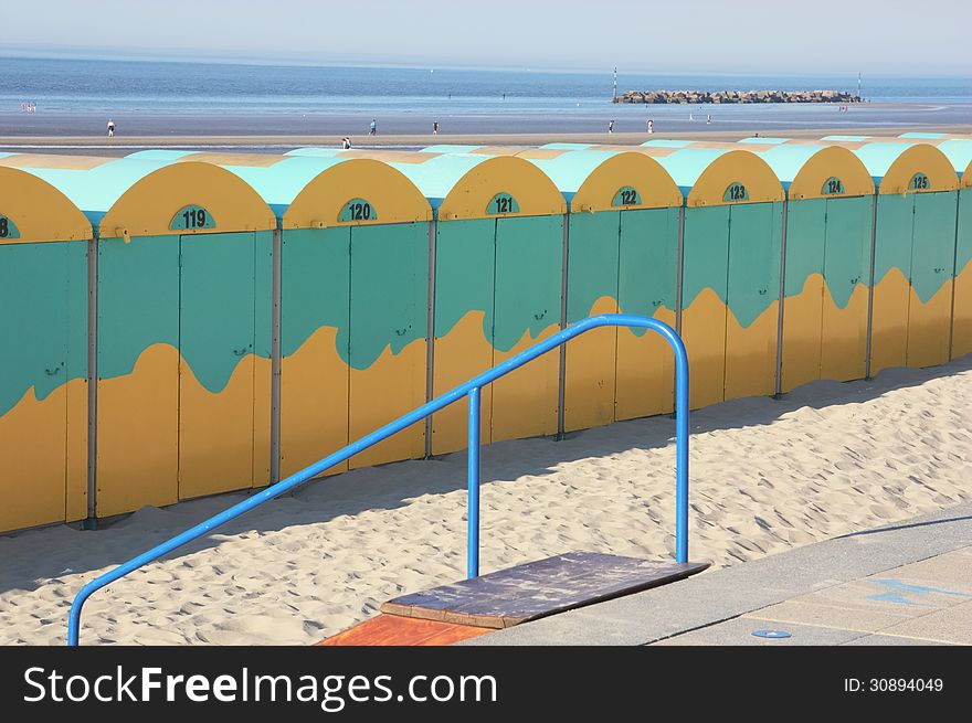 Beach huts alignment on a large beach in northern France