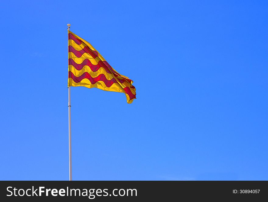 The catalan flag, in front of blue sky